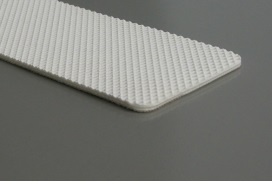 A length of white food grade PVC belt, its top face finished in a fine raised pattern. A length of white food grade PVC belt, its top face finished in a fine raised pattern.