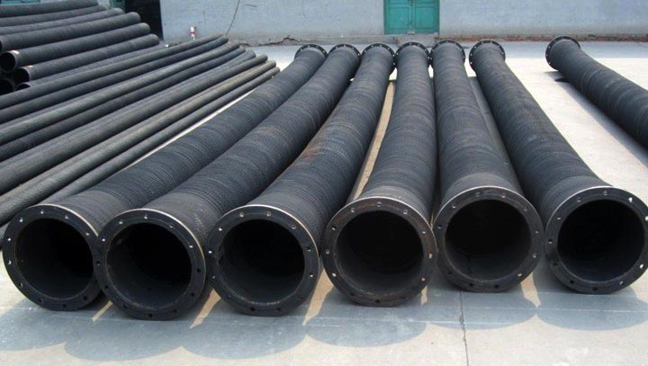 Finished fly ash bulker hoses laid in rows on the works floor, each with a flange at the end. Finished fly ash bulker hoses laid in rows on the works floor, each with a flange at the end.