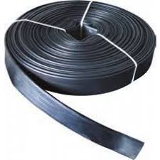 A coil of layflat water discharge hose, flat as it is wound and round at the open end. A coil of layflat water discharge hose, flat as it is wound and round at the open end.