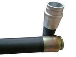 A concrete pump hose with a steel elbow coupling at the end. A concrete pump hose with a steel elbow coupling at the end.
