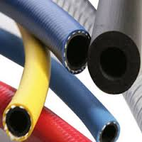 Braided delivery hoses in blue, yellow, red and black, gathered with their cut ends towards the camera. Braided delivery hoses in blue, yellow, red and black, gathered with their cut ends towards the camera.