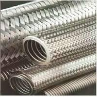 Stainless steel corrugated flexible hoses in a braided sleeve, coiled together. Stainless steel corrugated flexible hoses in a braided sleeve, coiled together.
