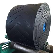 A full roll of chevron patterned belting on its stand, the V cleats running across the outer wrap. A full roll of chevron patterned belting on its stand, the V cleats running across the outer wrap.
