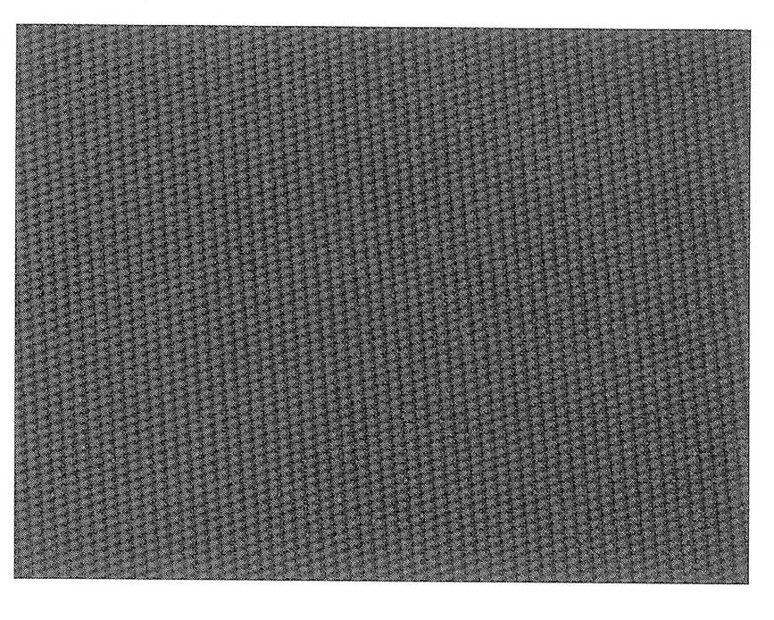A sheet of flat rubber belting for a combine harvester, its fine ribbed surface filling the frame.