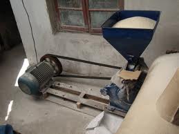 A long double V belt drive running from a motor to a rice machine in a mill.