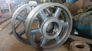 Large spoked V pulleys in the works, waiting at the balancing machine.