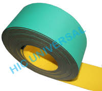 A roll of nylon core flat belting, green on one face and yellow on the other.