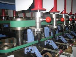 A green flat belt driving the head of a textile machine.