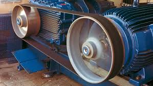 A flat belt running from an electric motor to the pulley of the machine it drives.