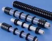 Four impact idlers of different lengths, each ringed with rubber discs, laid out together. Four impact idlers of different lengths, each ringed with rubber discs, laid out together.