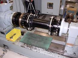 A turbine shaft coupling being set up on the machine bed in a workshop. A turbine shaft coupling being set up on the machine bed in a workshop.