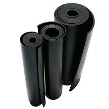 Four rolls of rubber sheeting of different widths standing together.