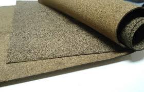 A sheet of nitrile rubberised cork curled back, the cork granules visible across its face.