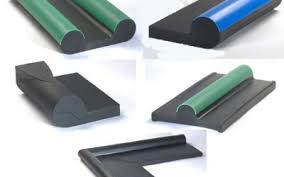 Moulded rubber packing profiles in black, green and blue, laid out to show their sections.