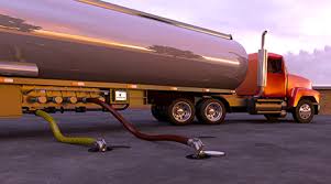 A road fuel tanker with a yellow hose coupled to its discharge point. A road fuel tanker with a yellow hose coupled to its discharge point.