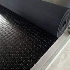A roll of anti slip rubber flooring part unwound, round studs raised across its face. A roll of anti slip rubber flooring part unwound, round studs raised across its face.